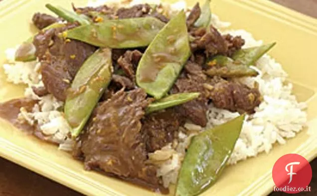 Manzo all'arancia saltato in padella e piselli di neve