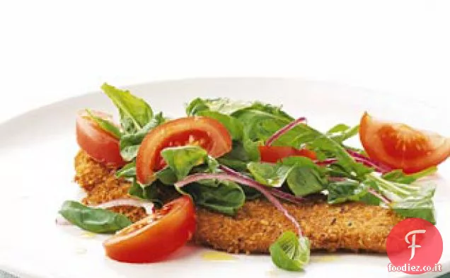 Cotolette di vitello con rucola e insalata di pomodori
