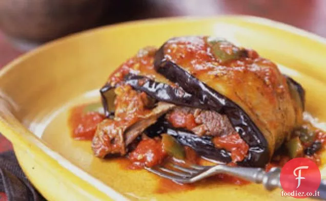 Stinchi di agnello brasati avvolti in melanzane