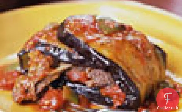 Stinchi di agnello brasati avvolti in melanzane
