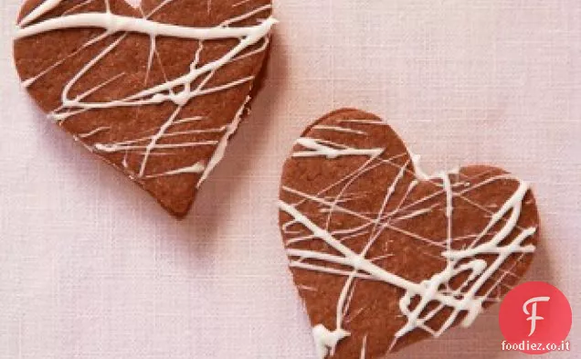 Biscotti sandwich al cioccolato ripieni di Ganache bianca