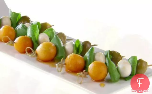 Mini Spiedini di melone e oliva con miele di pepe nero