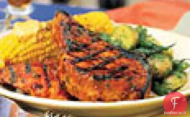 Pollo e maiale alla griglia con glassa di cumino all'arancia